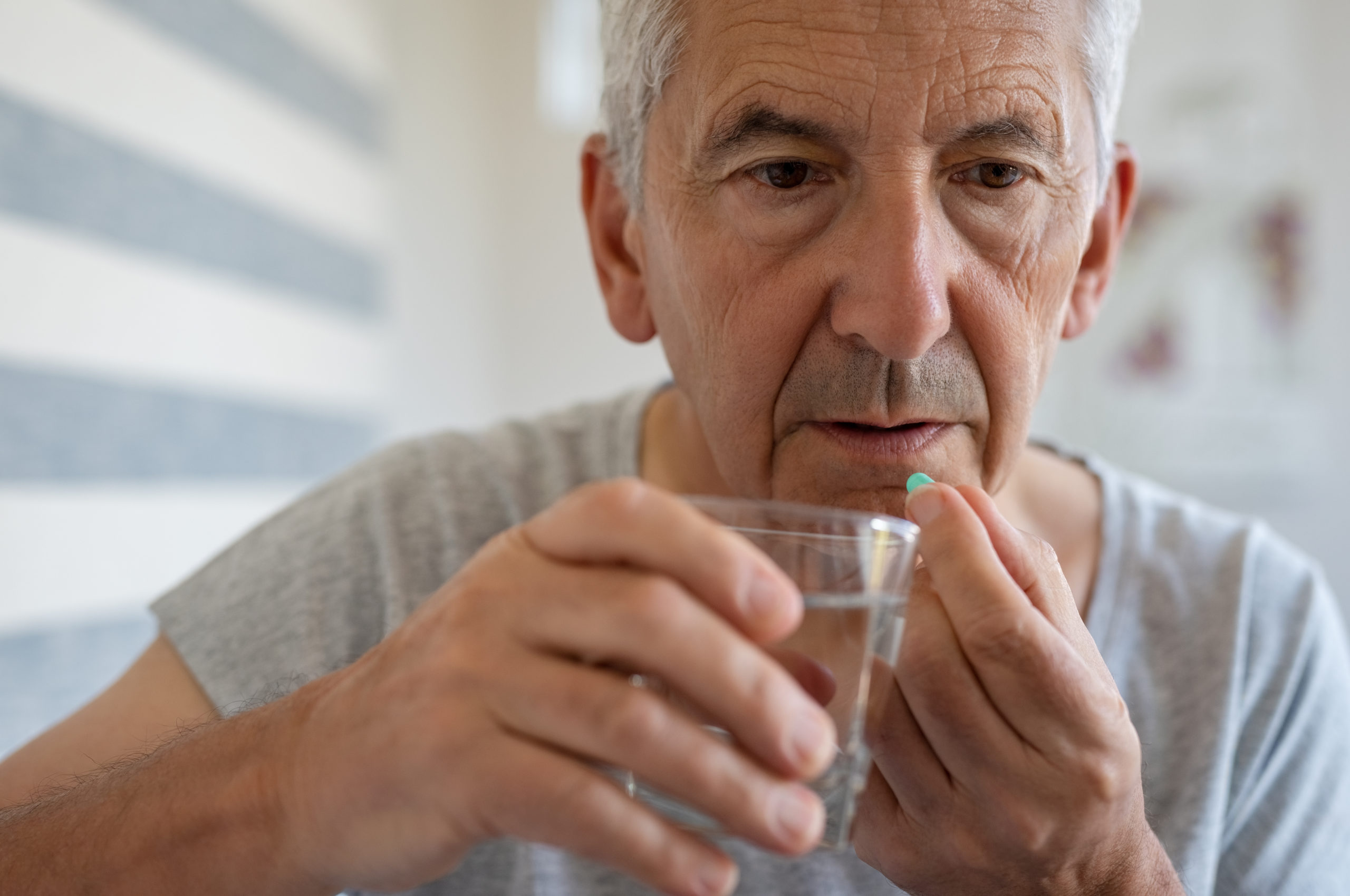 Senior man taking medicine