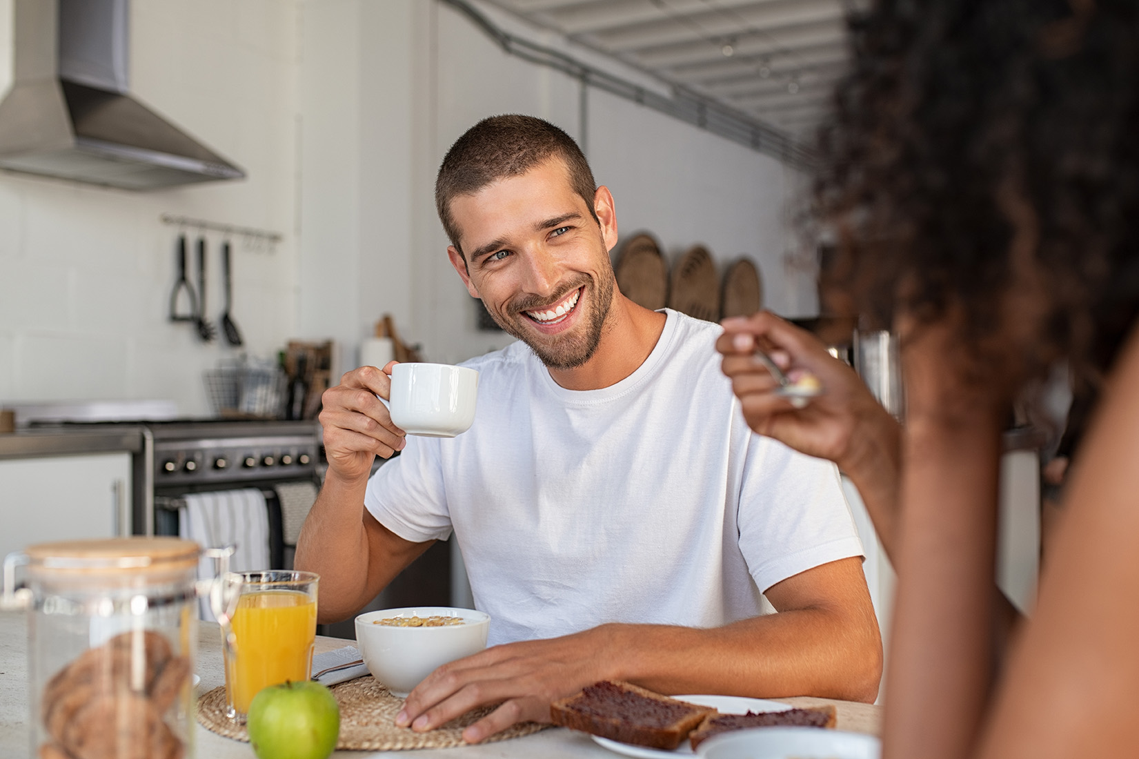 Man enjoying breakfast with african woman