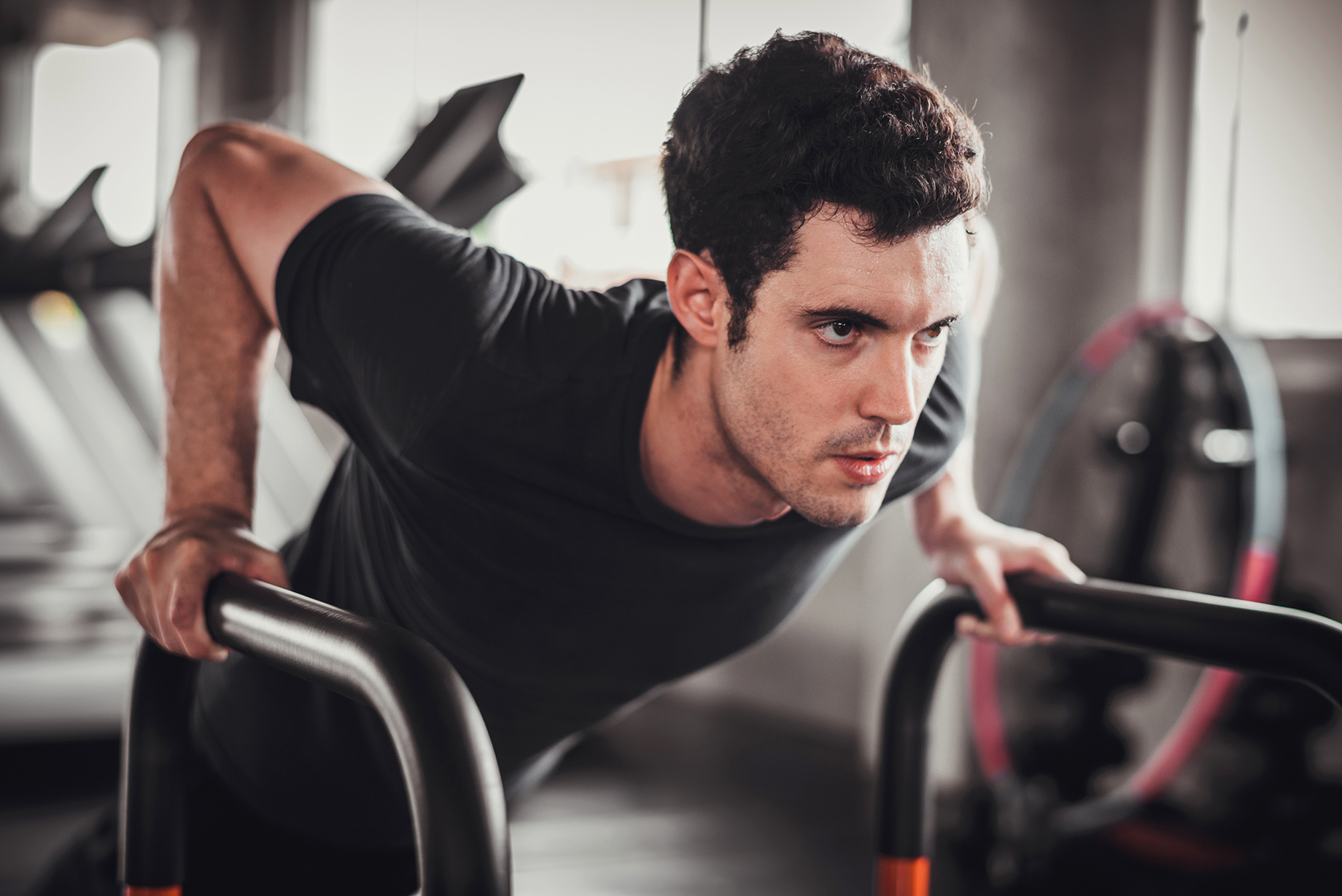 Cinematic tone of young attractive fitness man exercise with mac