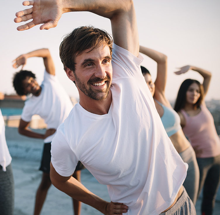 Fitness, sport, friendship and healthy lifestyle concept . Group of happy people exercising